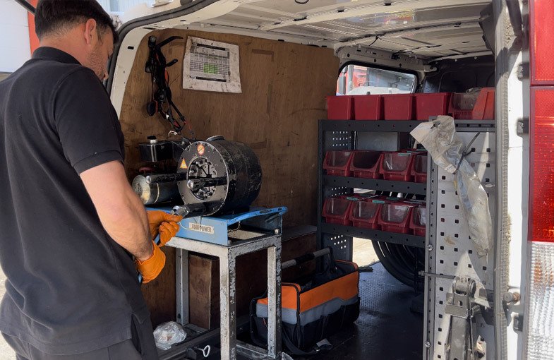 man working in the back of the van to help mobile on-site repair